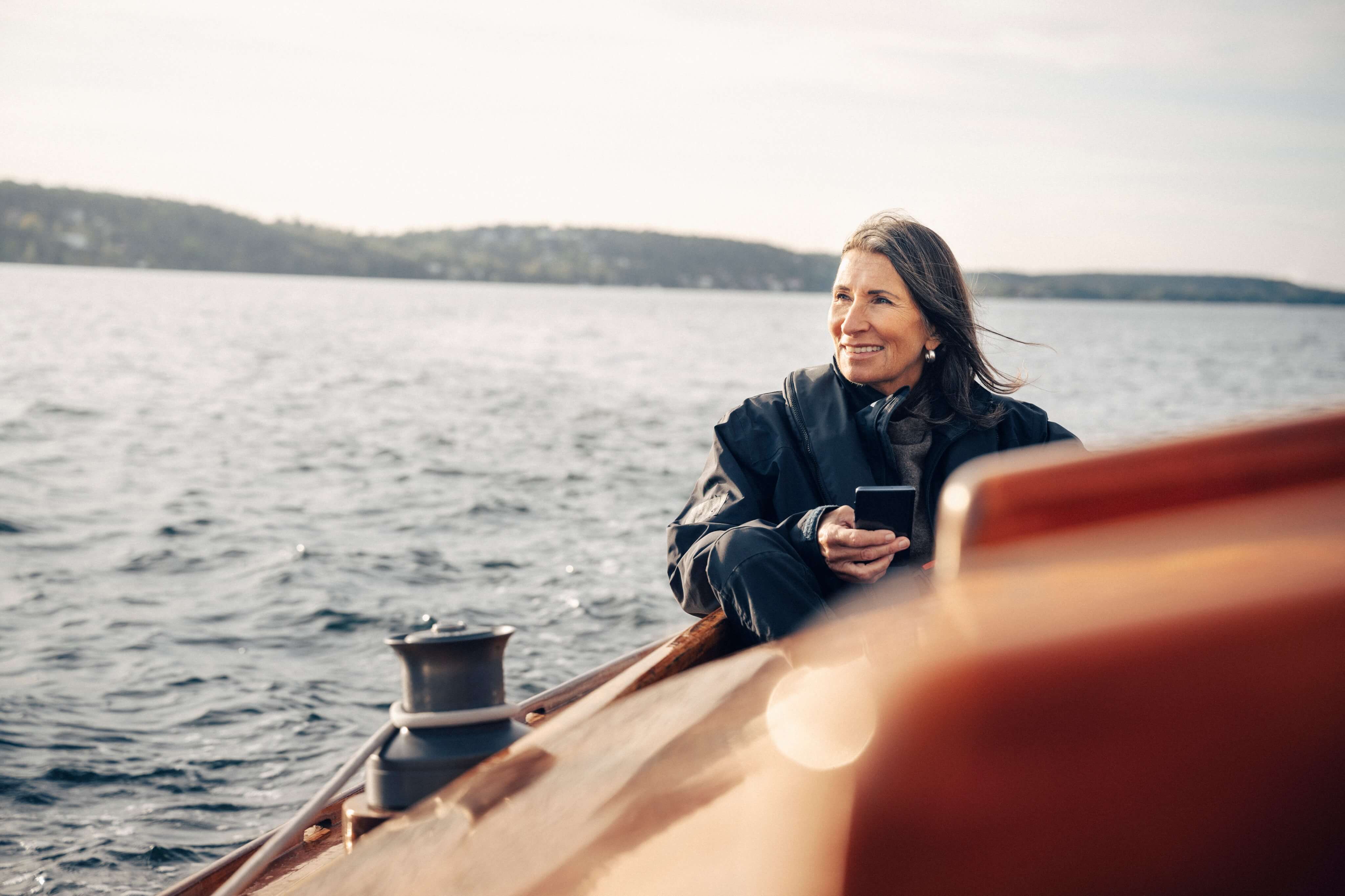 Woman sailing at sea with mobile